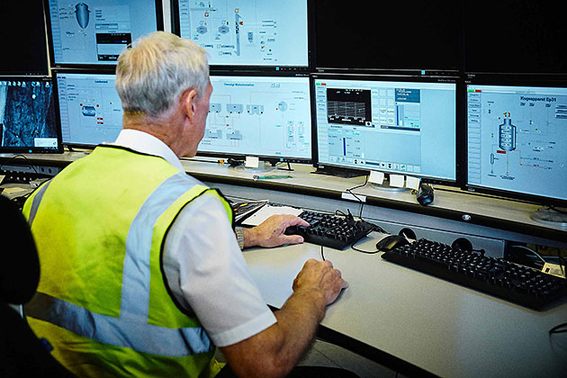 Worker monitoring production at sugar factory Worker monitoring production at sugar factory